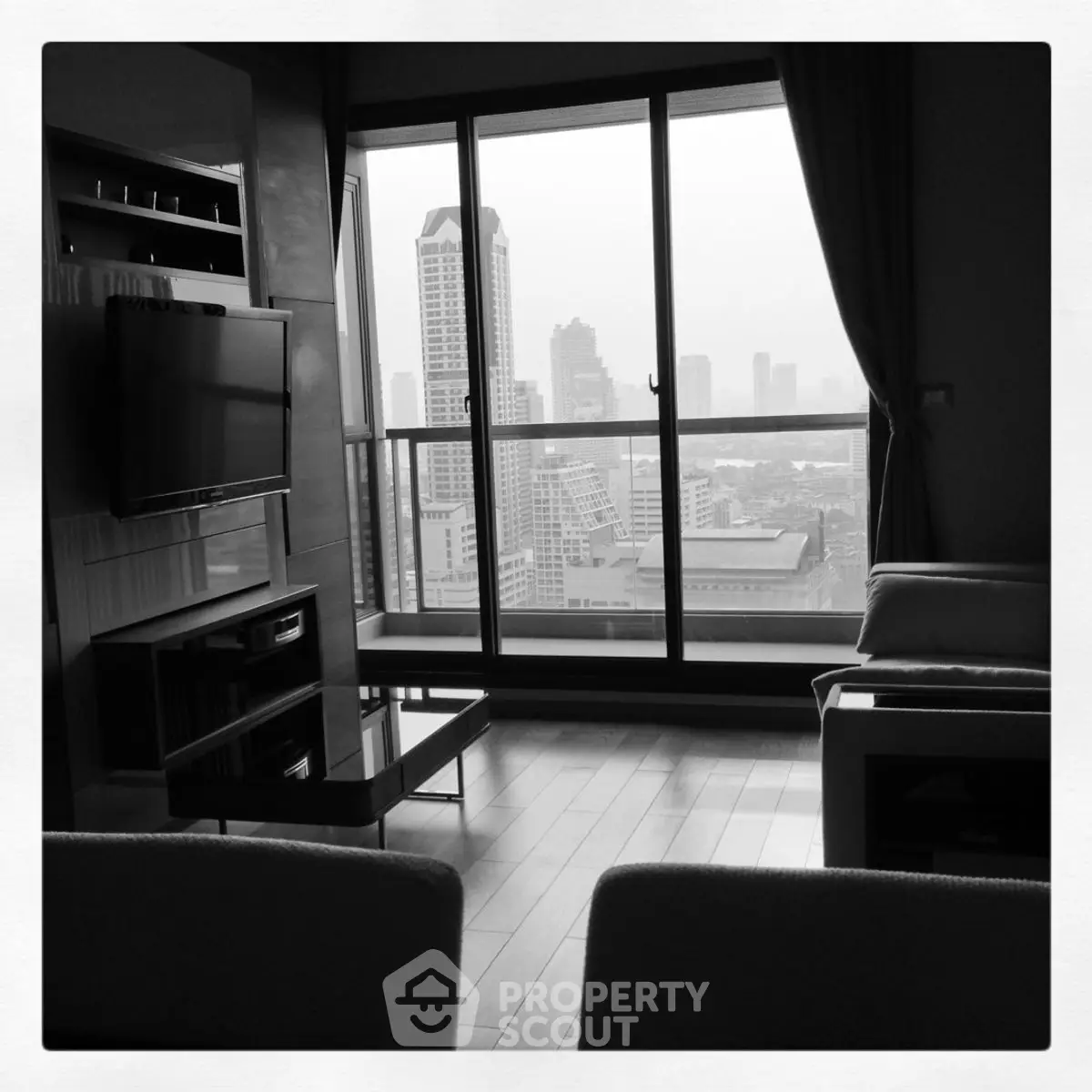 Modern living room with stunning city view and sleek furniture design.