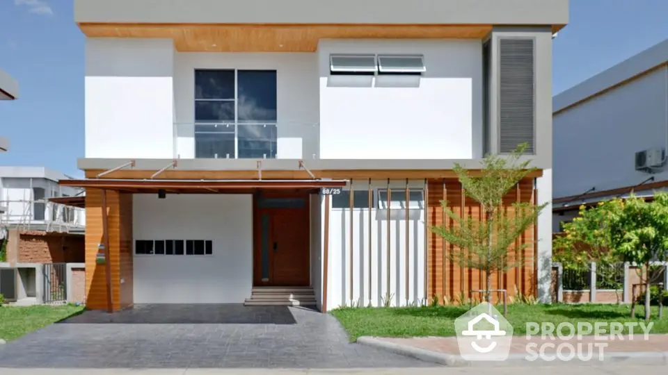 Modern two-story house with wooden accents and lush green lawn