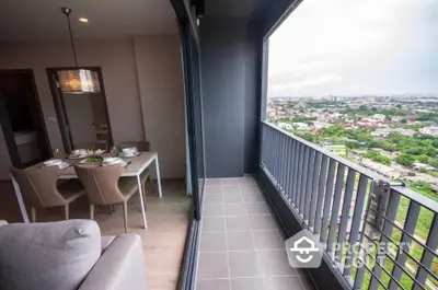 Modern apartment with spacious balcony offering stunning city views and elegant dining area.