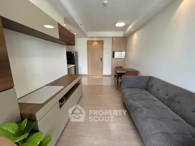Modern living room with sleek furniture and wooden flooring in a stylish apartment.