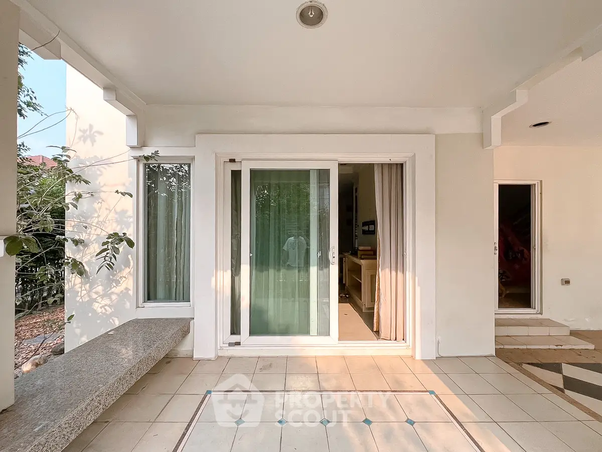 Charming patio entrance with sliding glass doors and tiled flooring