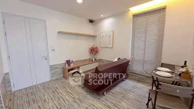 Modern living room with sleek design and cozy dining area, perfect for urban living.
