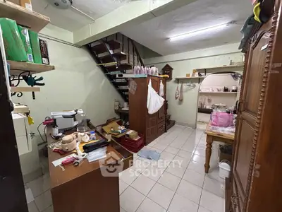 Cozy storage space with staircase and tiled floor, ideal for organizing household items.