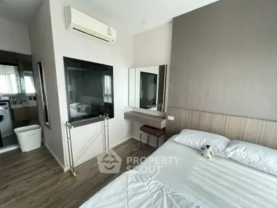 Modern bedroom with stylish decor and air conditioning, featuring a cozy bed and elegant vanity area.
