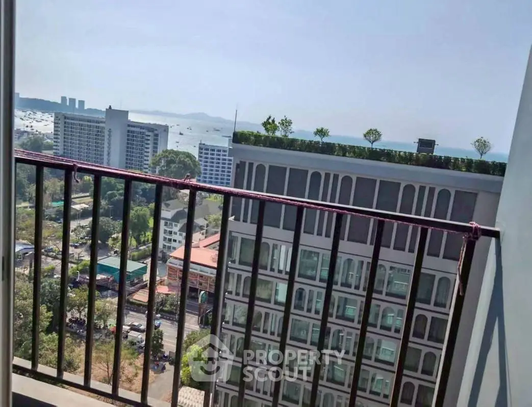 Stunning balcony view of cityscape and ocean, perfect for urban living.