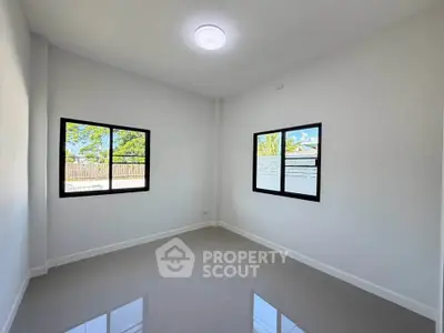 Bright empty room with large windows and glossy tiled floor, perfect for customization.
