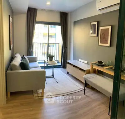 Modern living room with stylish decor and natural light, featuring a cozy sofa and elegant furnishings.
