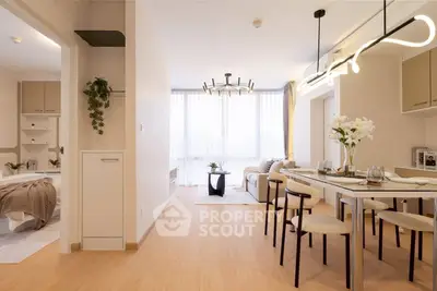Modern open-plan living and dining area with stylish lighting and cozy decor.