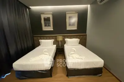 Modern twin bedroom with elegant decor and ambient lighting