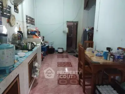 Cozy kitchen with dining area and tiled flooring in a compact home setting.