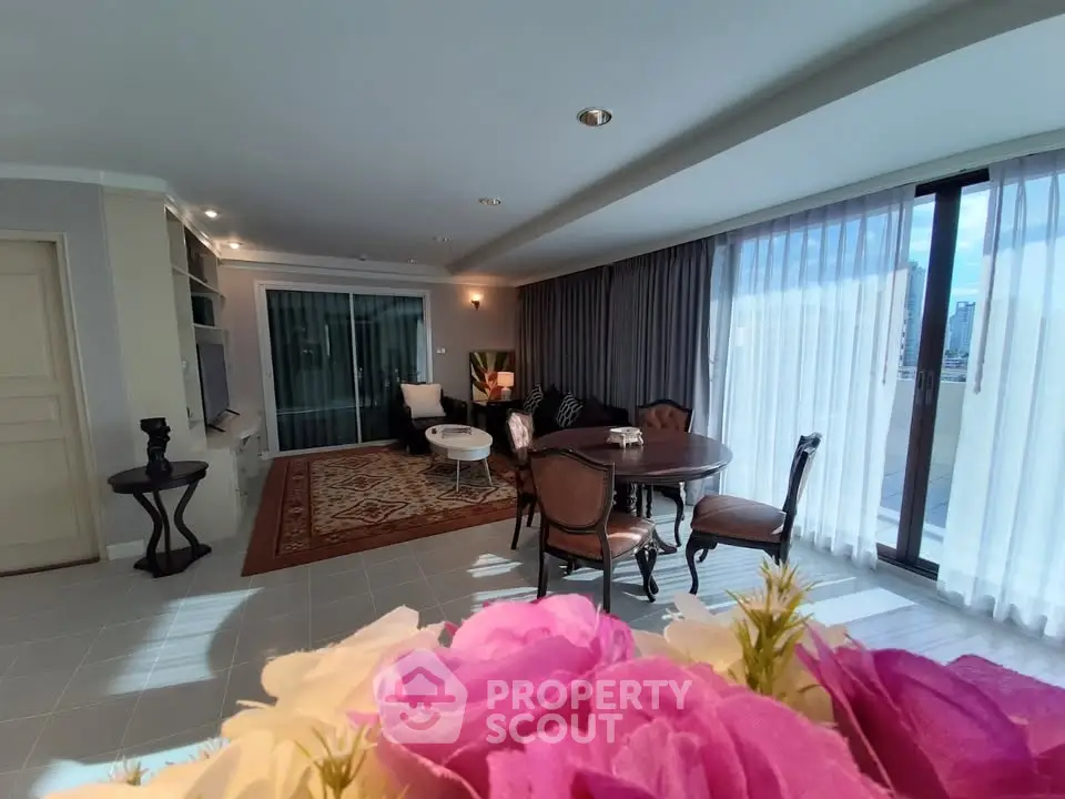 Spacious living room with elegant decor and large windows offering natural light.