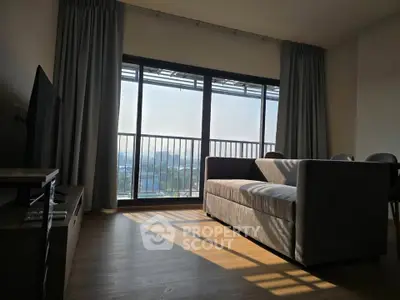 Modern living room with large windows and balcony view, featuring stylish furniture and abundant natural light.