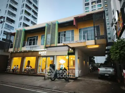 Modern commercial building with vibrant facade and outdoor seating area