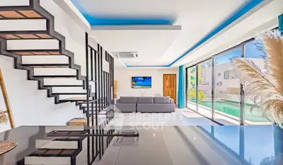 Modern living room with sleek staircase and pool view, featuring contemporary design and abundant natural light.