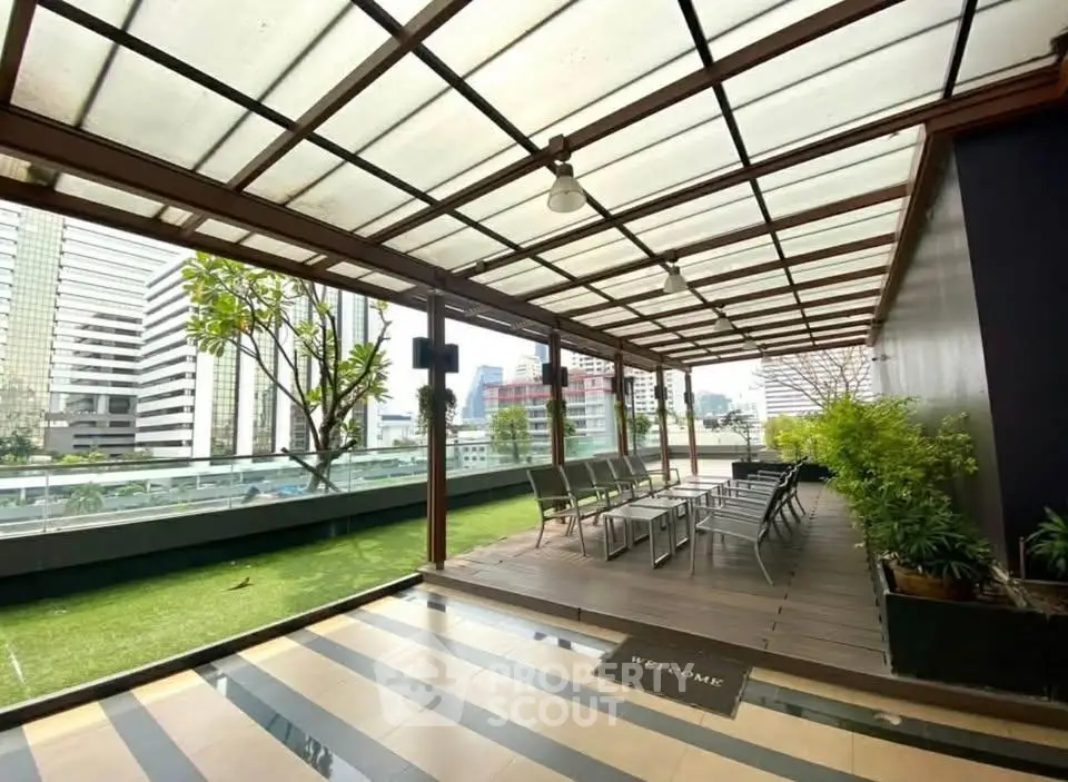 Stylish rooftop terrace with city views and modern seating area in urban setting.