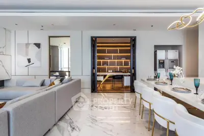 Luxurious open-plan living and dining area with modern decor and marble flooring.