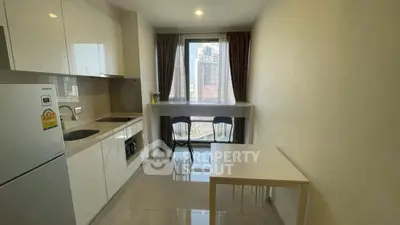 Modern kitchen with sleek white cabinets and city view from window