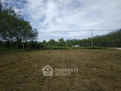 Expansive plot of land with lush greenery and clear skies, perfect for development opportunities.