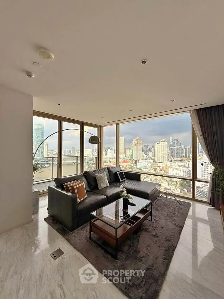 Luxurious living room with panoramic city views and elegant modern decor.