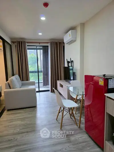 Modern living room with sleek furniture and balcony view in a stylish apartment.