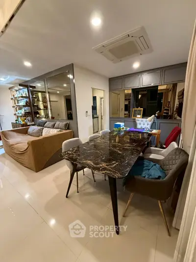 Modern living room with elegant marble dining table and cozy seating area