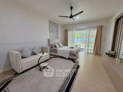 Spacious bedroom with elegant decor and large window view