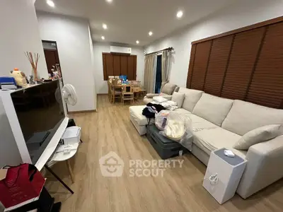 Spacious living room with modern decor and cozy seating area, perfect for relaxation.