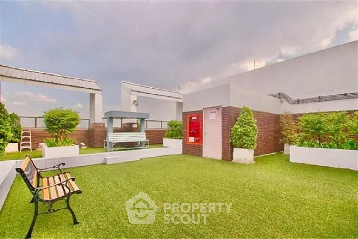 Stunning rooftop garden with lush greenery and seating area, perfect for relaxation and gatherings.