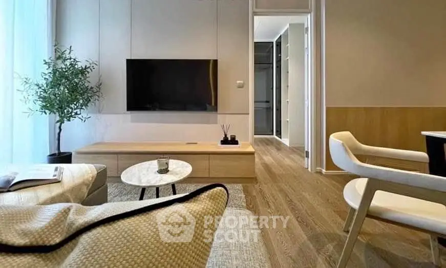 Modern living room with sleek furniture and wall-mounted TV, showcasing elegant interior design.