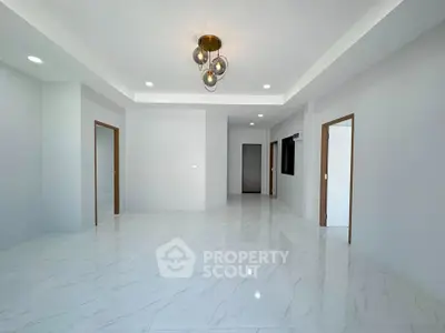Spacious modern living room with elegant lighting and glossy tile flooring