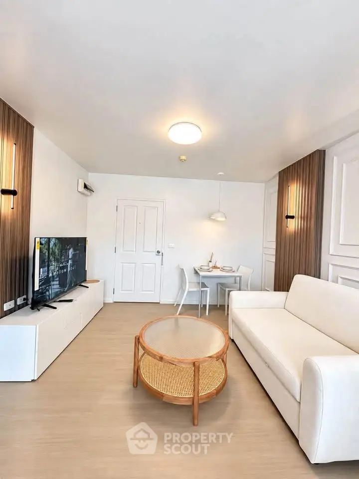 Modern living room with stylish furniture and natural light, perfect for relaxation and entertainment.