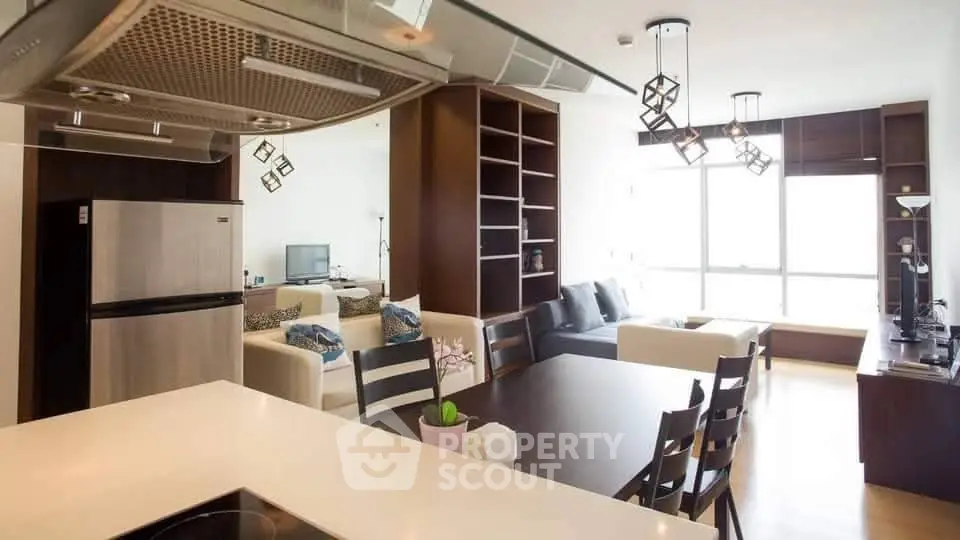 Modern open-layout living room with sleek kitchen and stylish decor