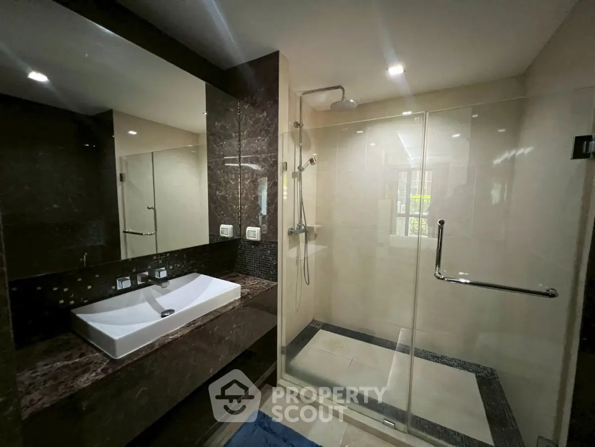 Luxurious modern bathroom with glass shower and elegant sink design