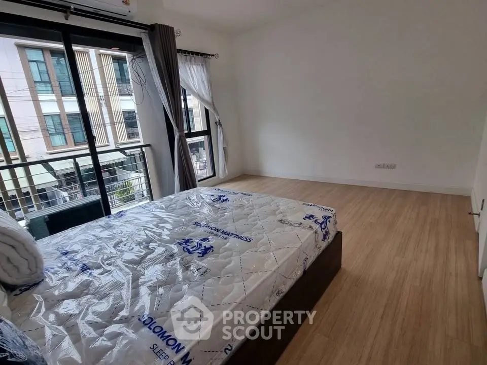 Spacious bedroom with large windows and modern design in a stylish apartment.