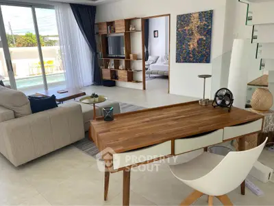 Modern living room with stylish wooden furniture and pool view, perfect for relaxation and entertainment.