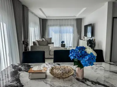 Luxurious modern living room with elegant marble table and plush seating, perfect for stylish entertaining.