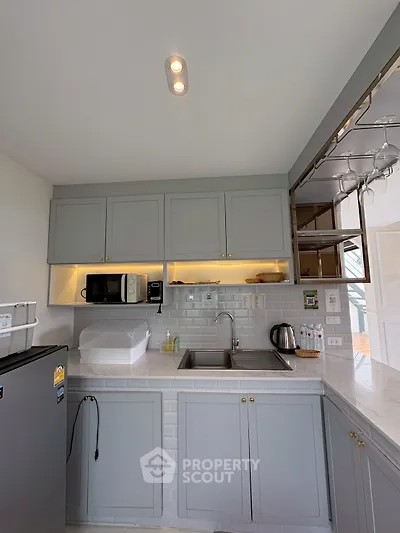 Modern kitchen with sleek cabinetry and built-in appliances in a stylish apartment.