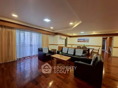 Spacious living room with elegant wooden flooring and modern furniture