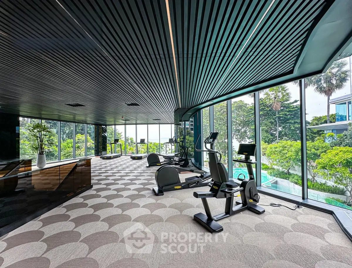 Luxurious gym with modern equipment and stunning garden views in a high-end residential building.