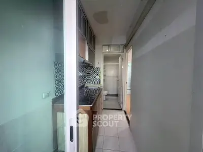 Compact kitchen with modern backsplash and sliding door