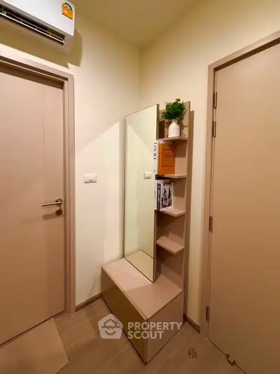 Compact entryway with mirror and storage shelves in modern apartment