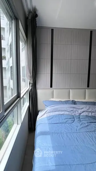 Modern bedroom with large windows and stylish decor