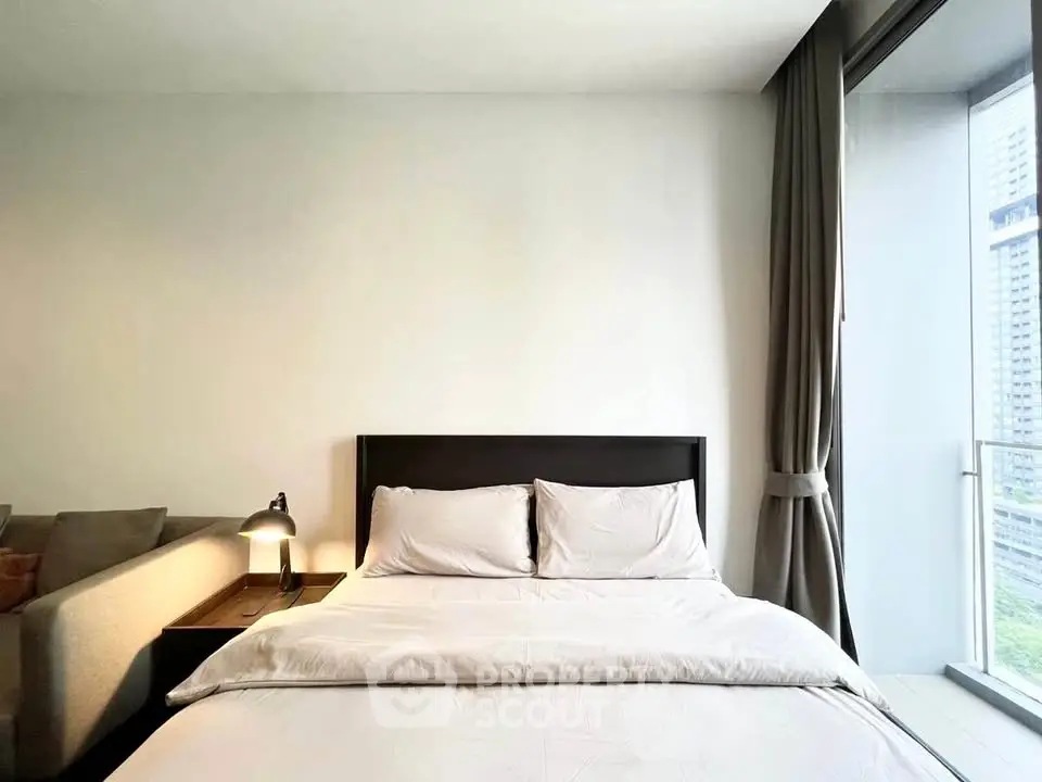 Modern bedroom with large window and cozy bed in urban apartment