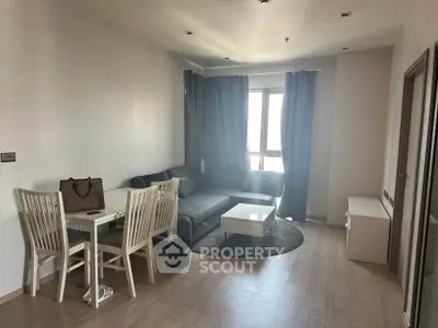 Modern living room with cozy seating and dining area, featuring elegant curtains and natural light.
