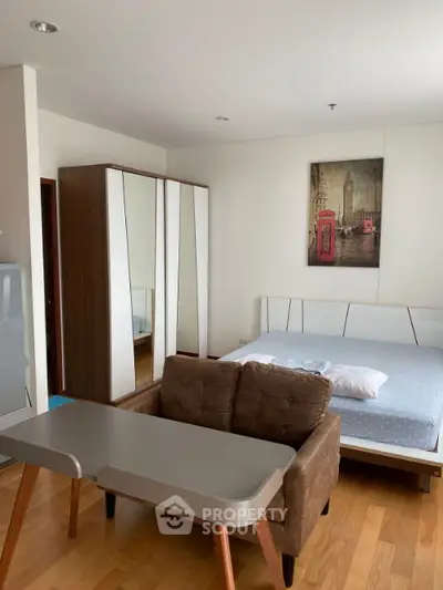 Modern bedroom with stylish furniture and wall art in a cozy apartment