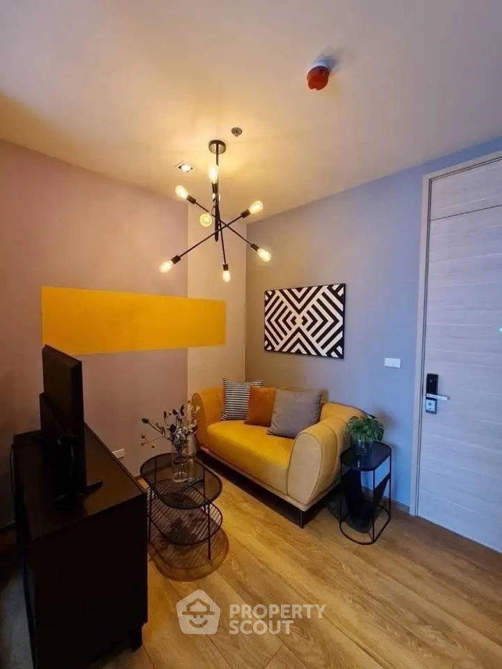 Stylish modern living room with chic lighting and cozy seating area.