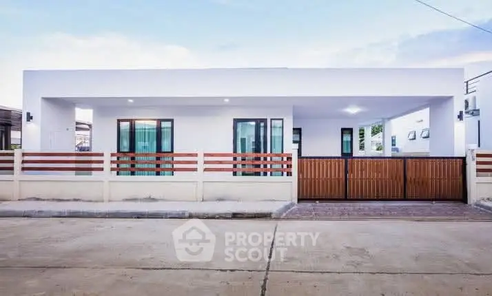 Modern single-story house with sleek design and spacious driveway, perfect for contemporary living.