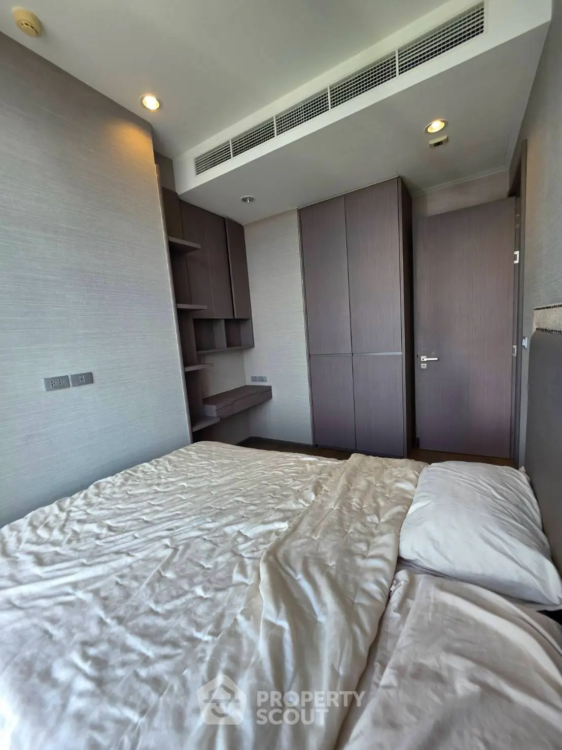 Modern bedroom with built-in wardrobe and cozy lighting