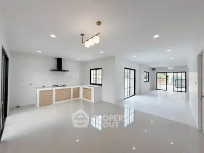 Spacious open-plan kitchen and living area with modern finishes and ample natural light.