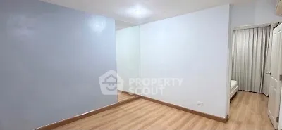 Spacious empty room with wooden flooring and mirrored wall, ideal for customization.